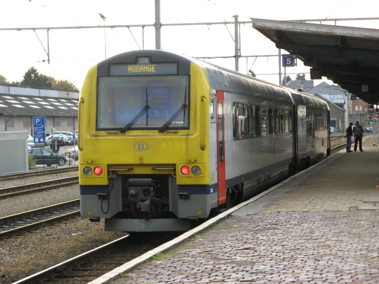 an image of a yellow train on tracks