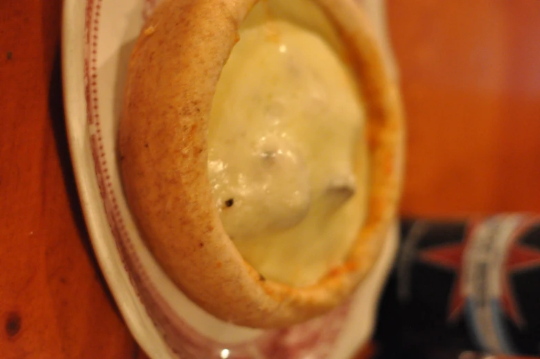 small crusty pie on a red and white plate