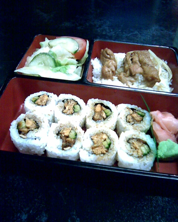 a meal with several different kinds of sushi and rolls