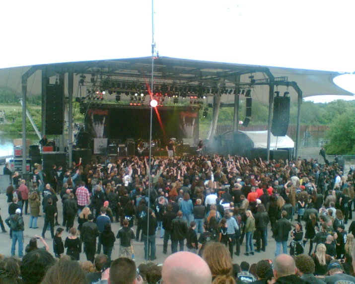 a large crowd of people in a park watching the show