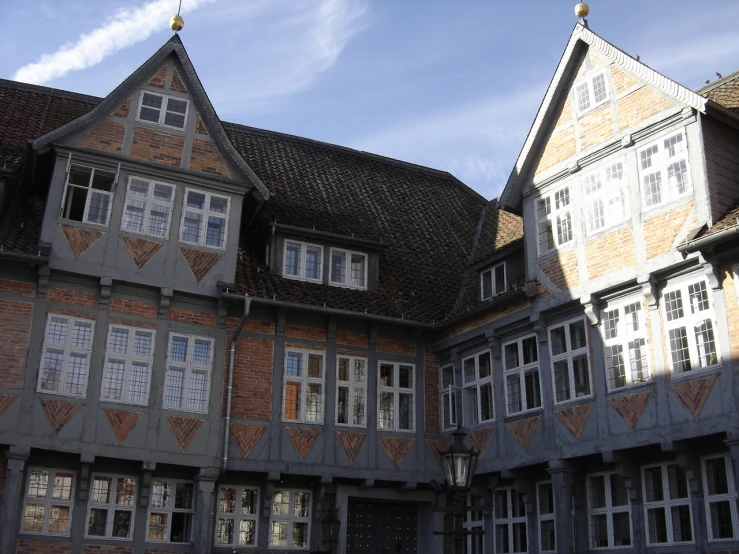 a large brown brick building with many windows