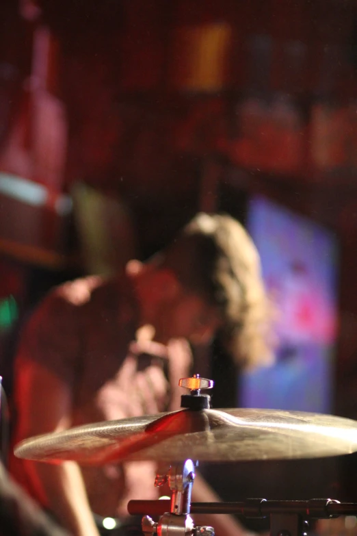 two people playing drums inside of a bar