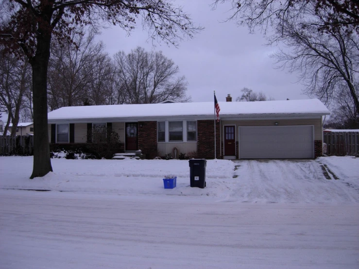 a driveway is covered in snow with a car parked in front of it