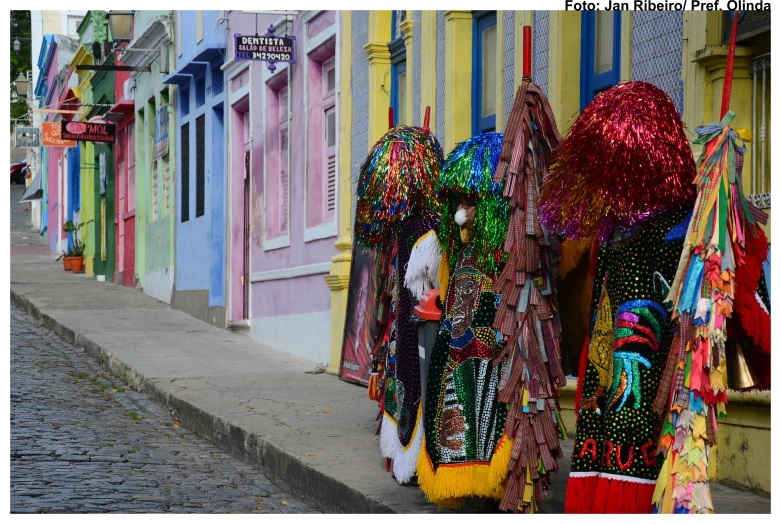 several colorful umbrellas are lined up on the side of the street