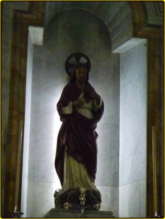 a statue of jesus at the cross surrounded by pillars