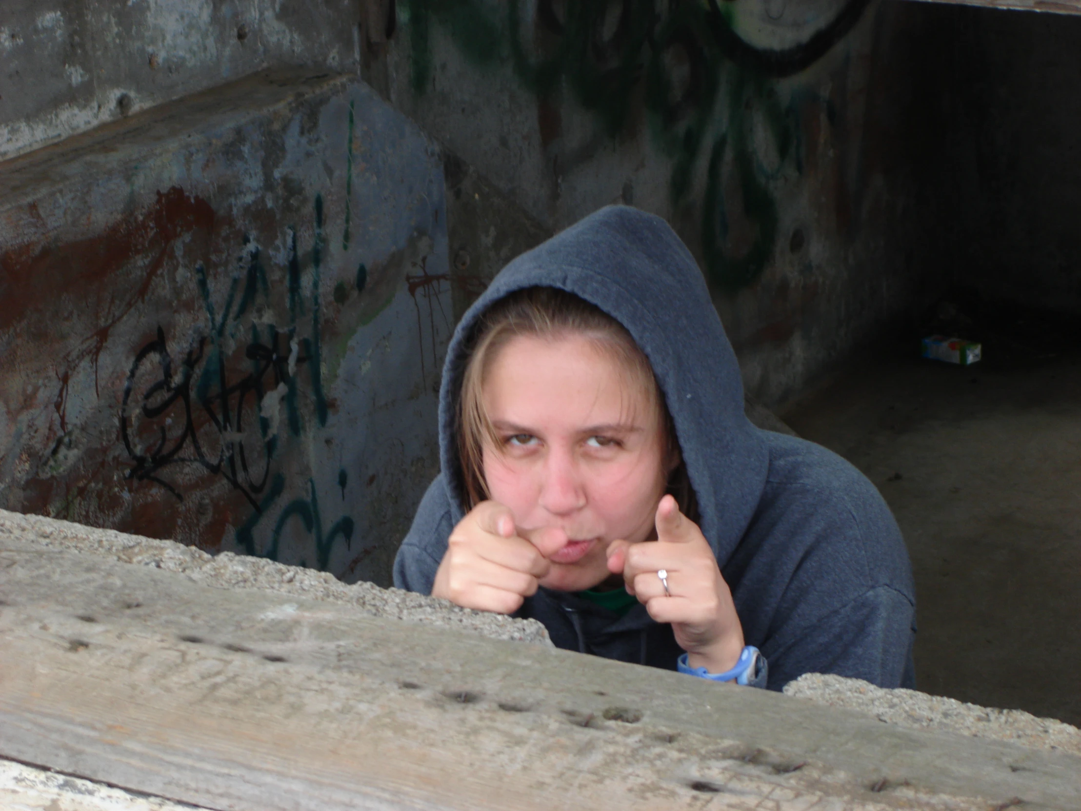 a person wearing a hoodie and pointing her finger