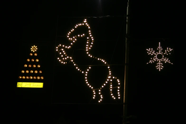 a large sign next to a christmas tree