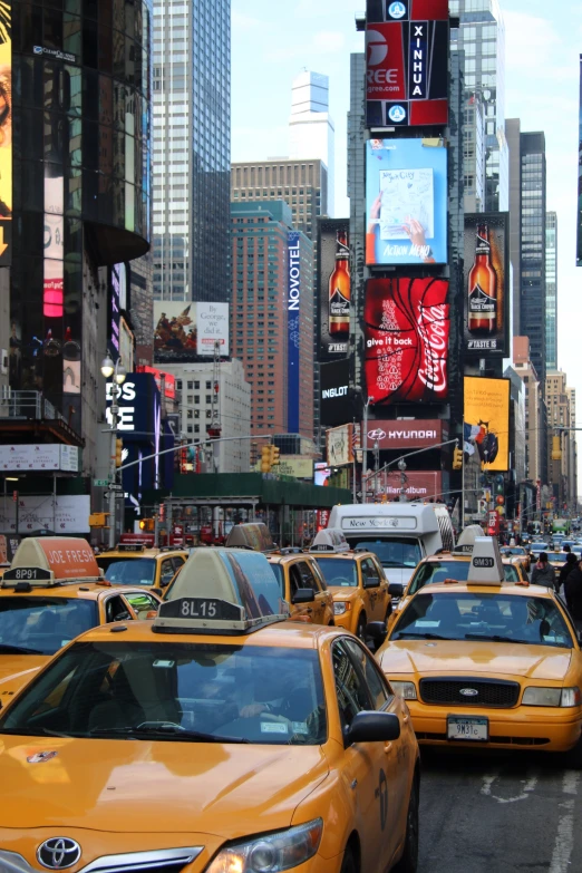 taxis drive down a busy street in new york city