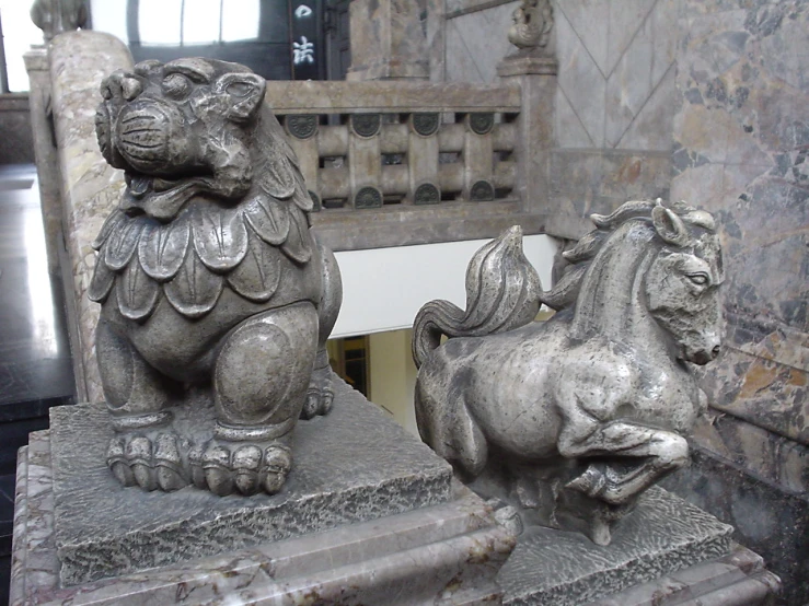 a couple of lion sculptures sitting on top of steps