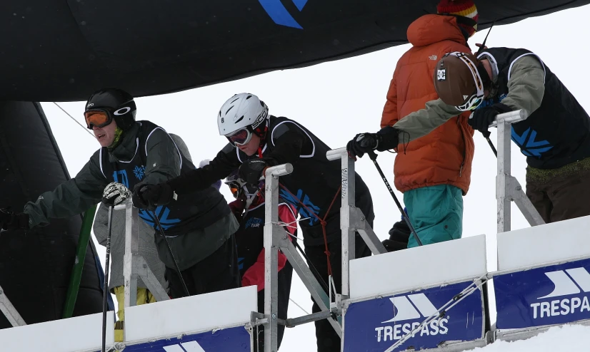 group of people walking up the side of a ski lift