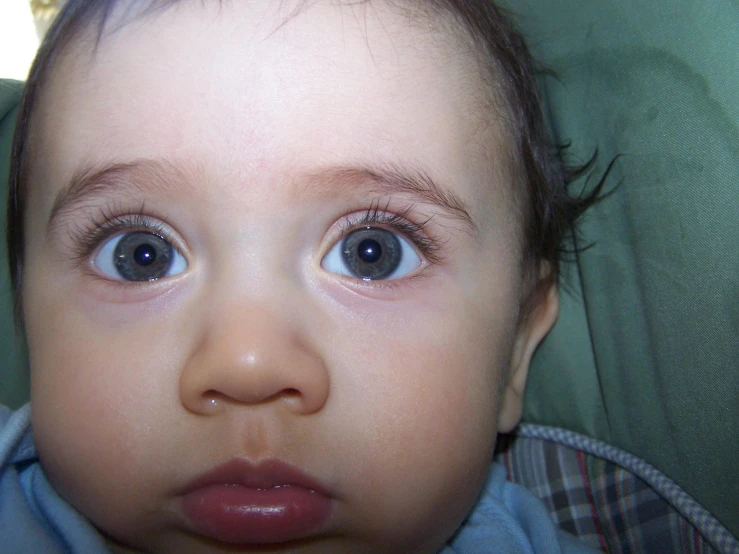 baby looking directly into camera with blue eyes