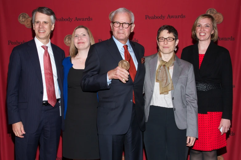 four people in suits are posing for a po together