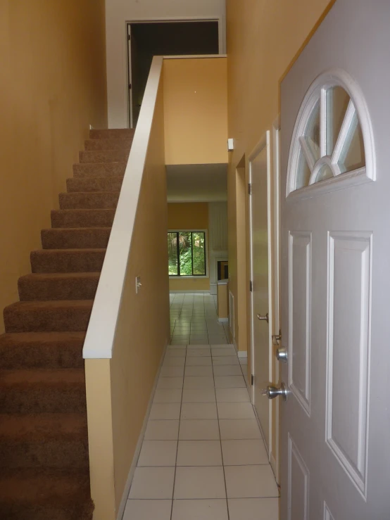 the hallway leads up to the second floor and another area in front