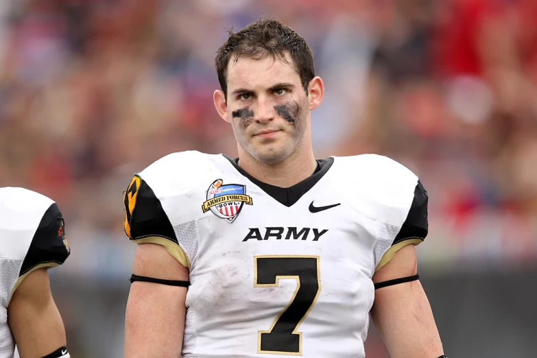 an army member wearing a black and gold uniform