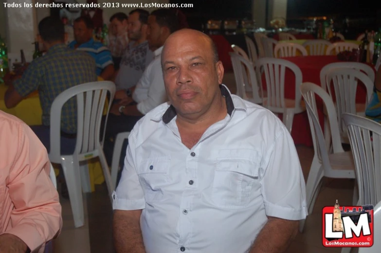 a man in a white shirt with an orange tie