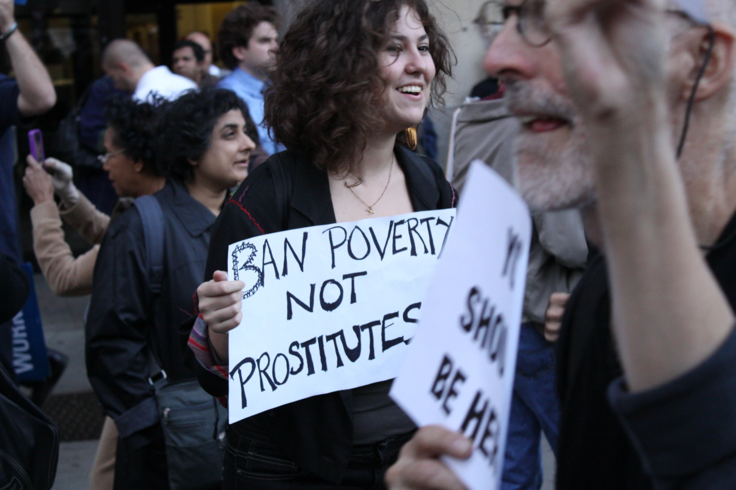 people holding signs and protesting against proposed government