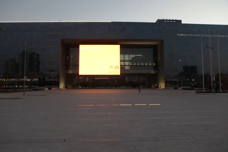 a person in a city square at dusk