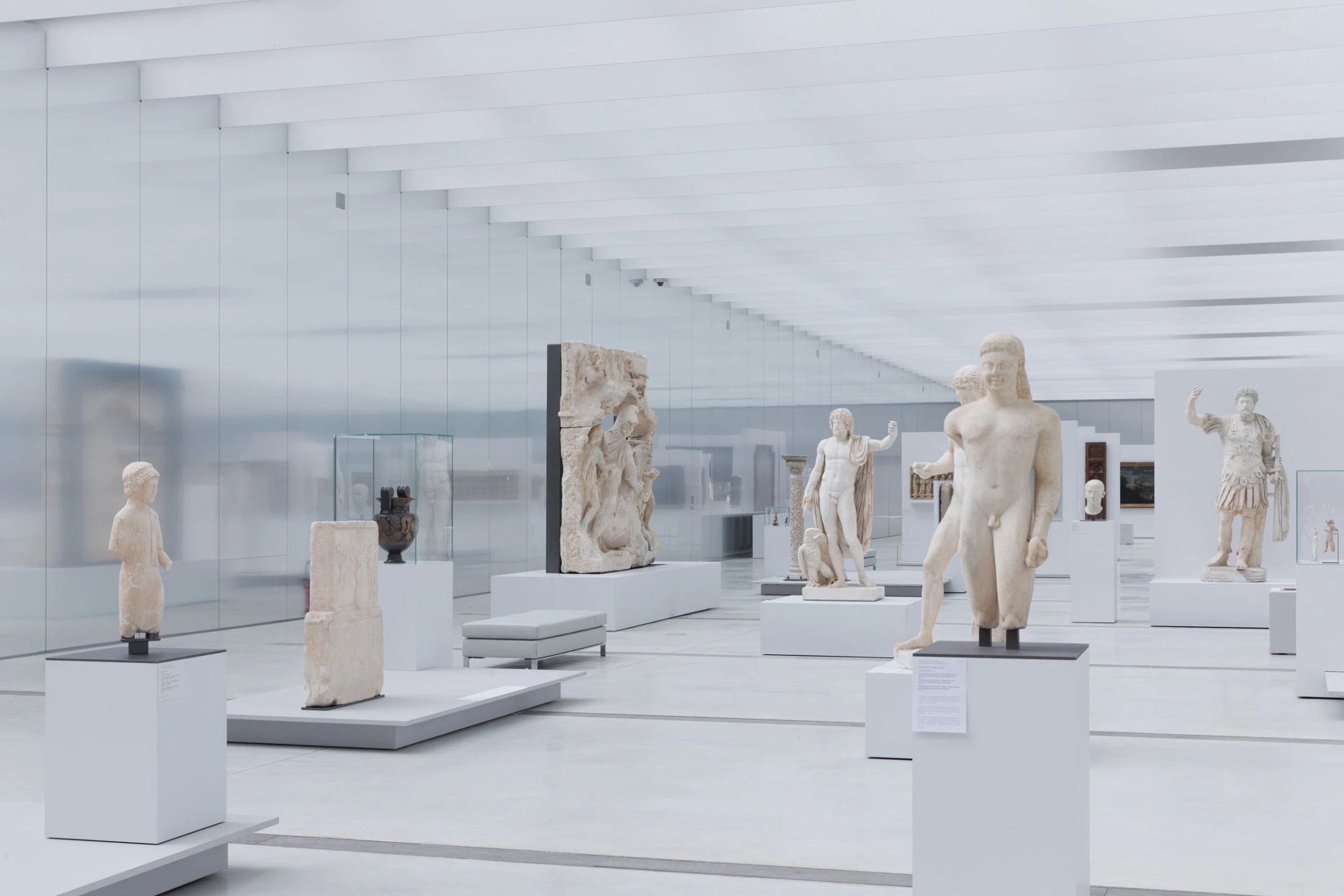 a room with statues all on pedestals