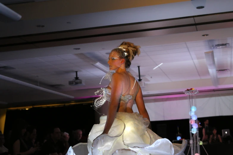 a model walks down the runway in a dress that's decorated with flowers