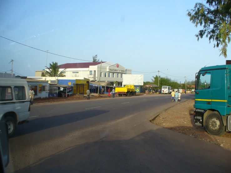 there is a blue truck that is sitting by the street