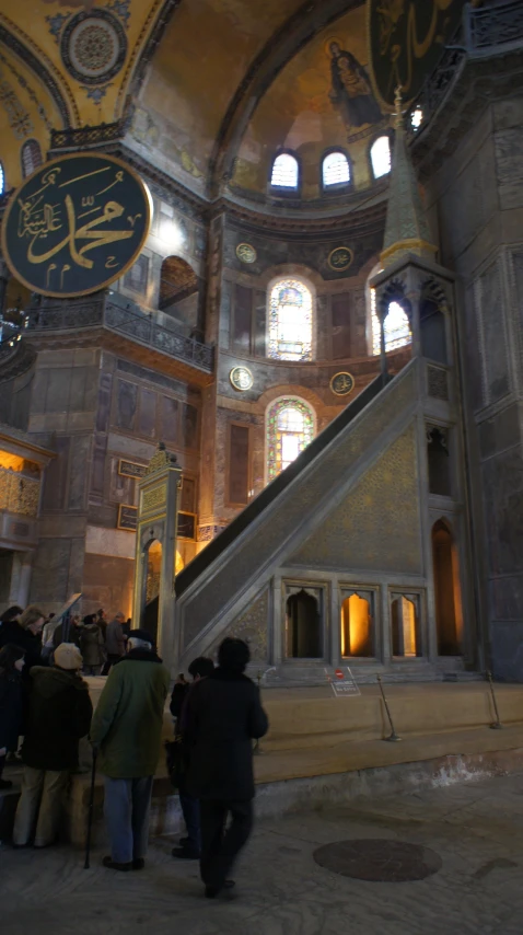 people inside an ornate building with stairs