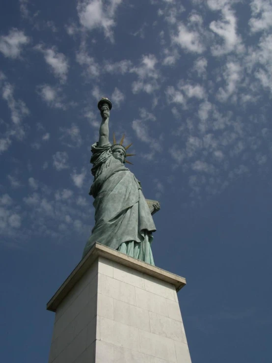 a view looking up at the head and shoulders of the statue of liberty