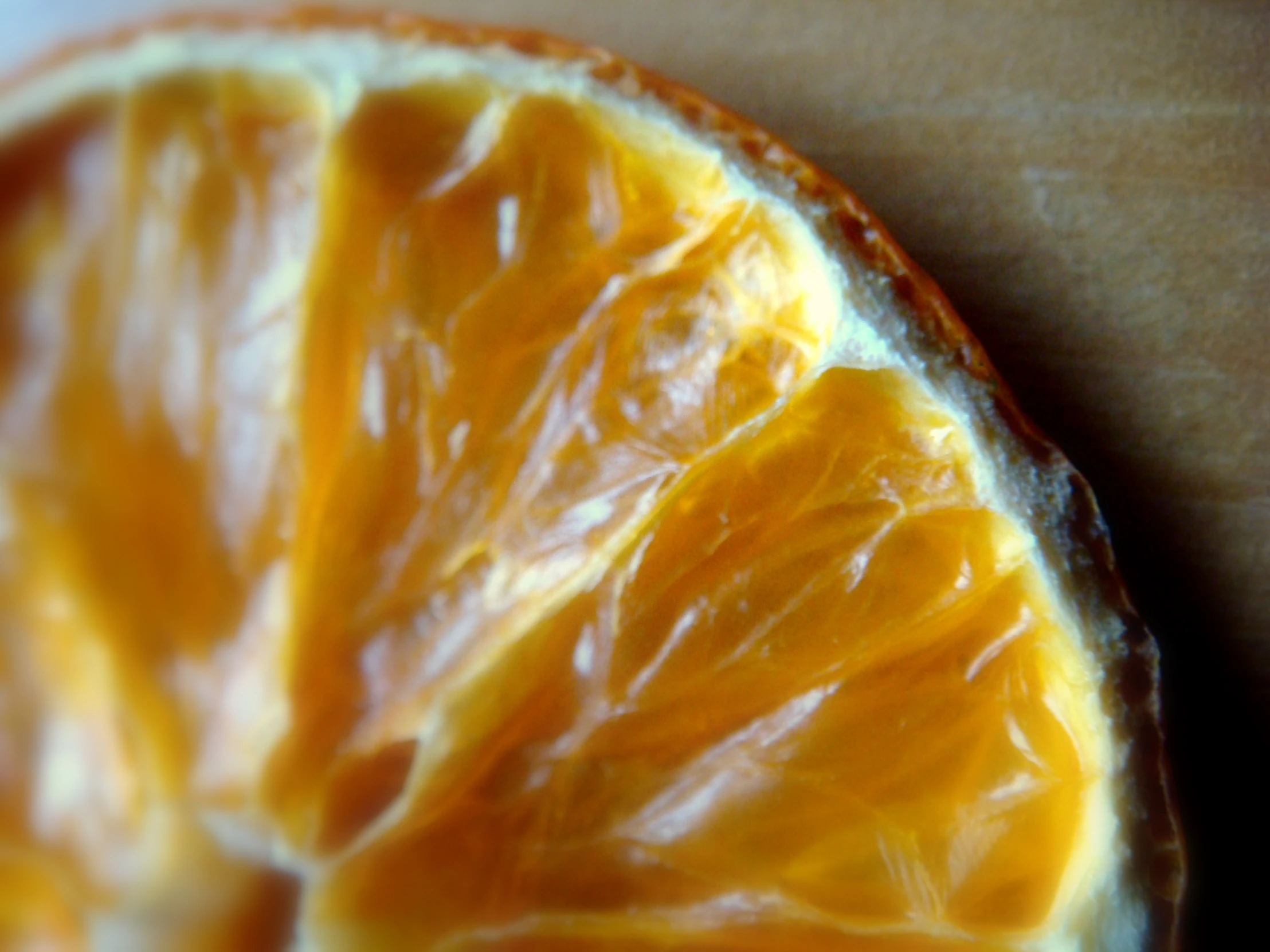 an orange slice being peeled by some brown paper