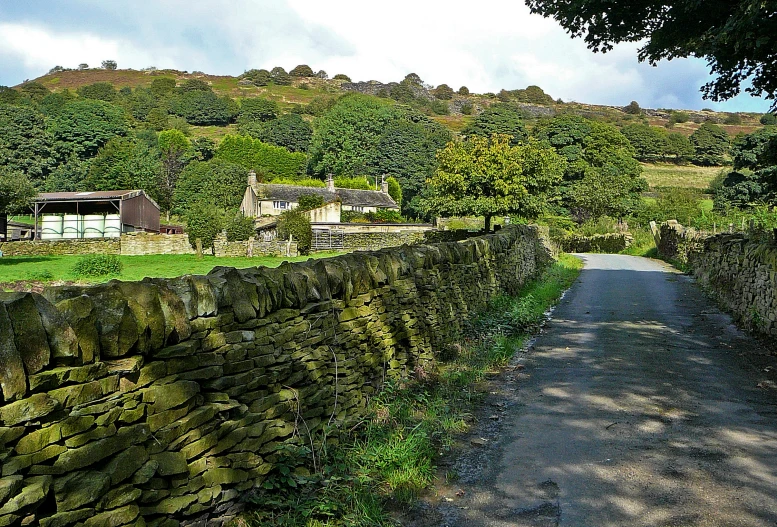 a stone wall with a house on top of it