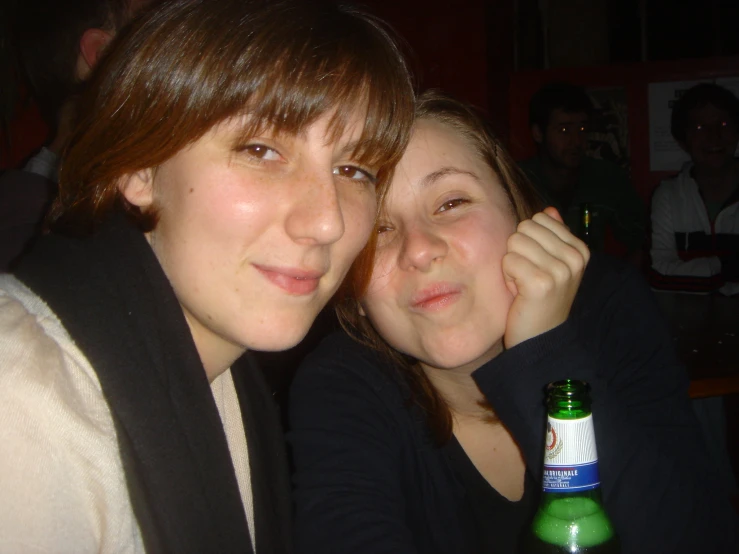 two young women pose for the camera with their bottles