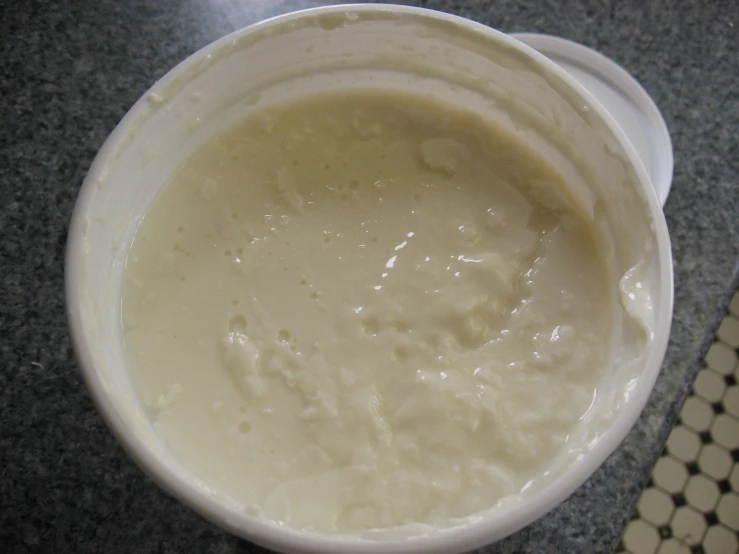 a large white bowl on a table with white tiles on it