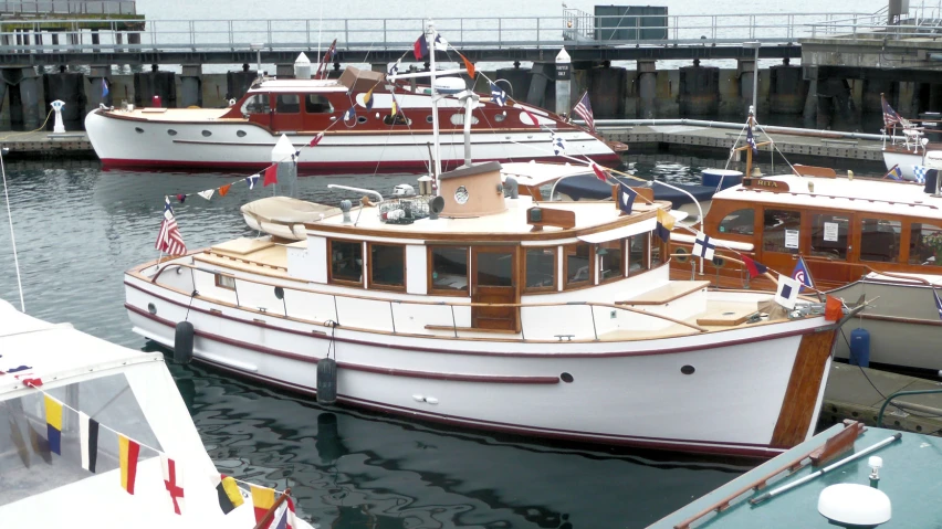 several boats docked in the water next to a bridge