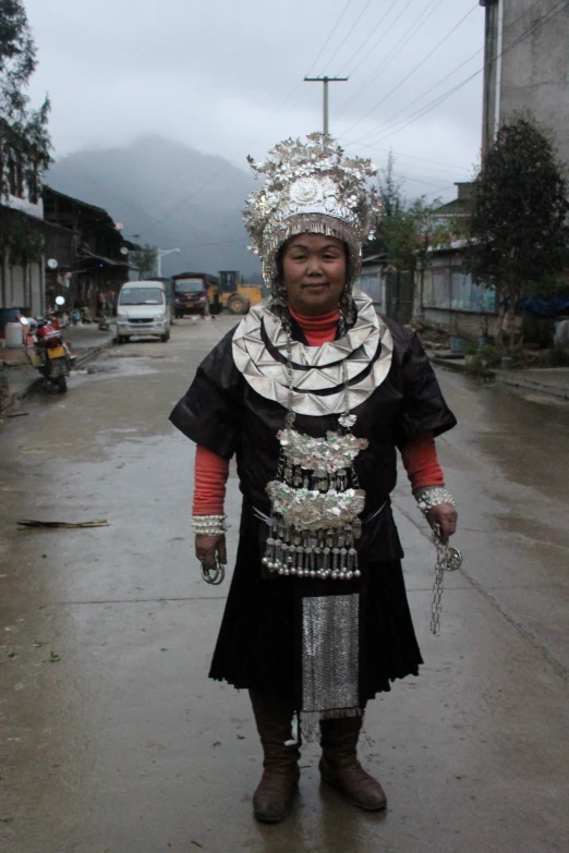 an indigenous woman standing in the middle of the street