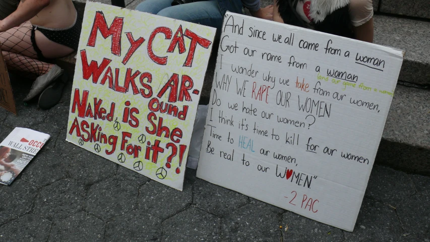 signs displayed on the steps stating their work and asking for payouts