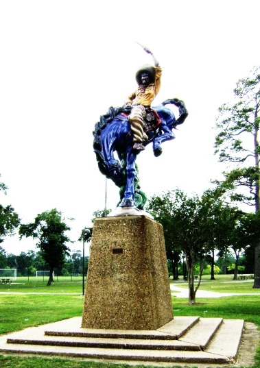 a statue of a man on a horse wearing gear and with wings