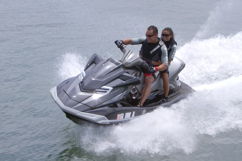 a man and woman on a jet ski going through the water