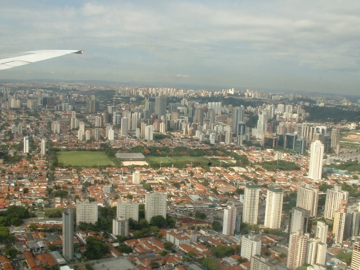 an airplane is flying above the city