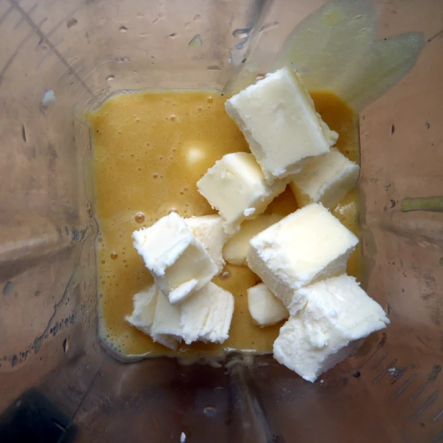 cubed chunks of cheese and milk in a blender