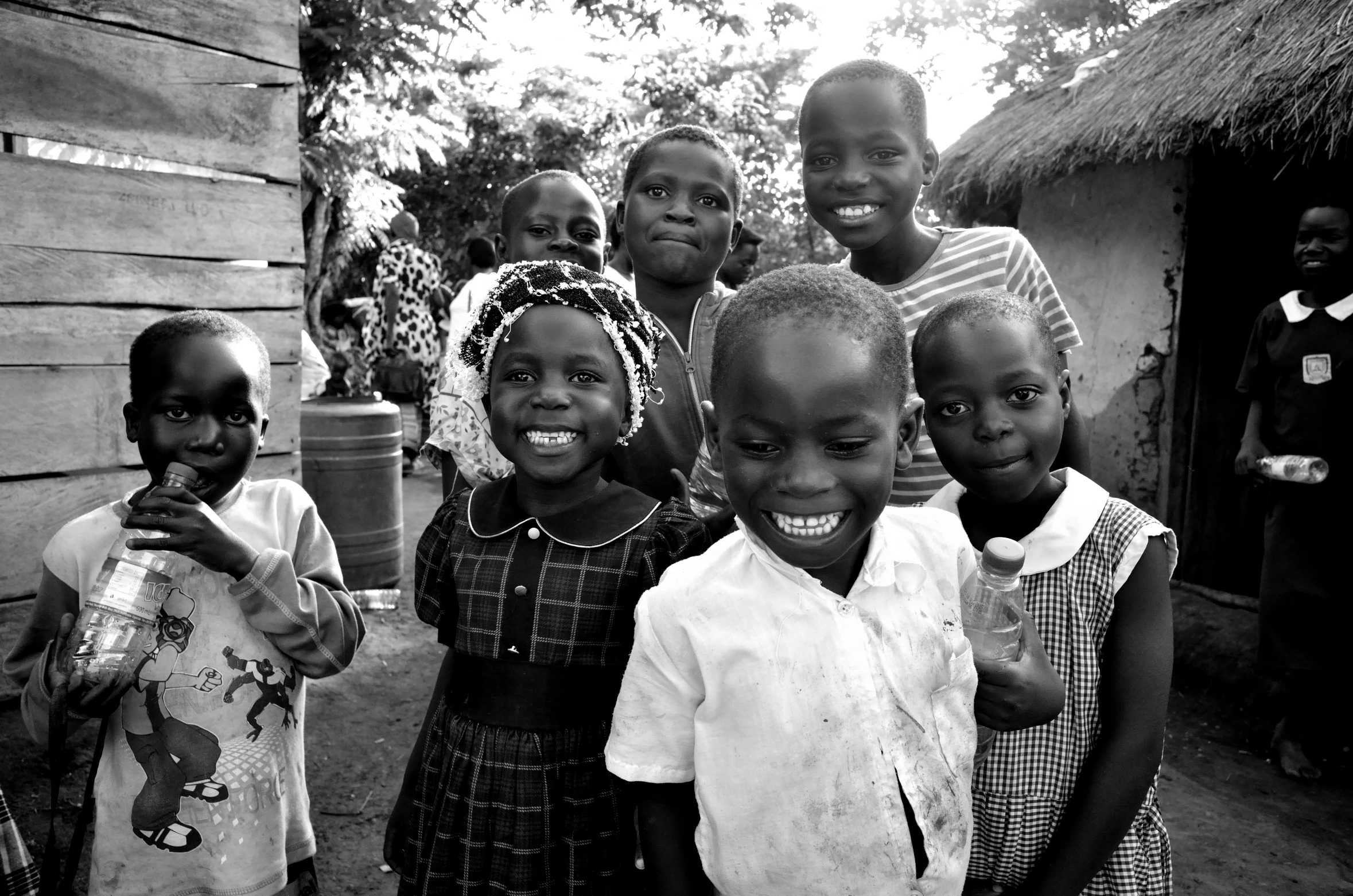 a group of young children standing outside of a building