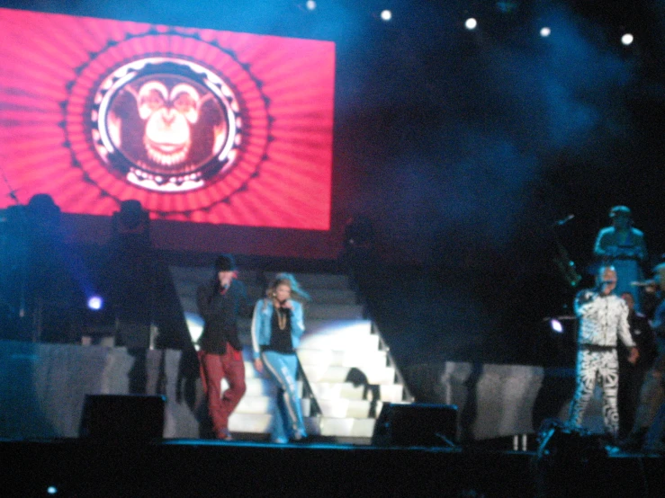 a group of people on stage during a concert