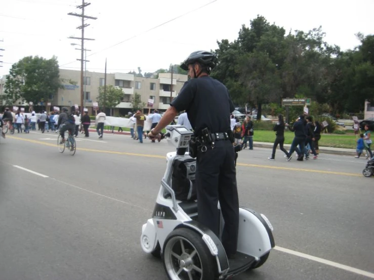 a police officer on a motor scooter in a city street