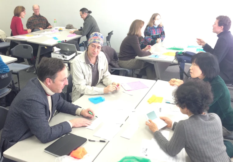 adults working together on design projects at a table