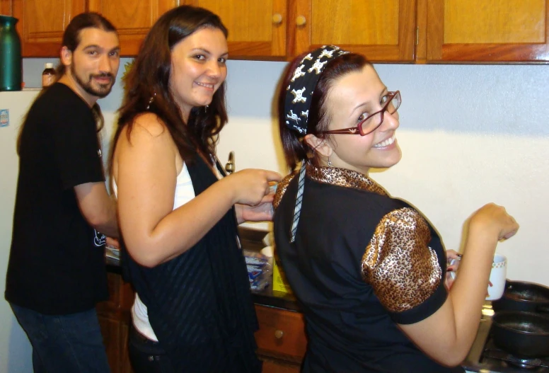 two people are posing for a picture in a kitchen