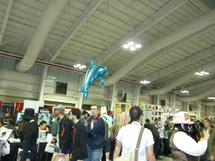 a dolphin balloon being flown in the air at an event