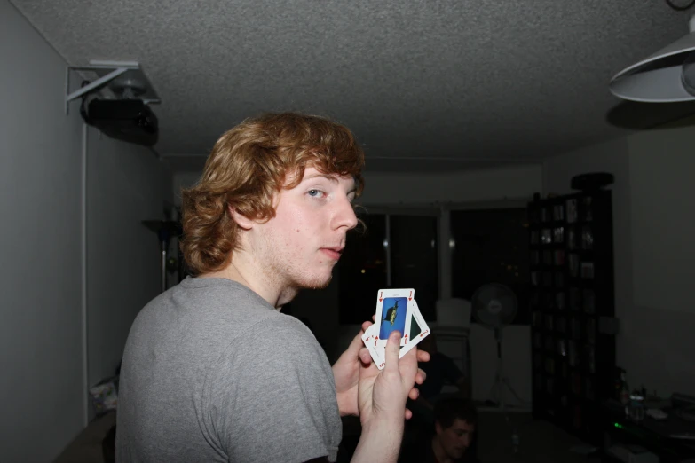 a young man holding a piece of construction paper