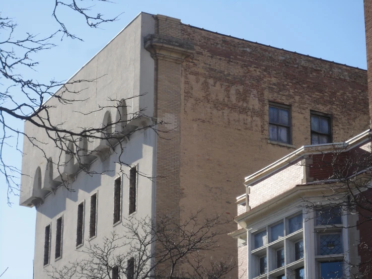 a tall brick building is shown against a blue sky