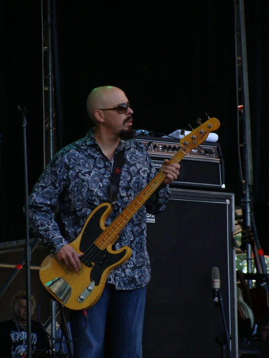 a man standing next to an electric guitar