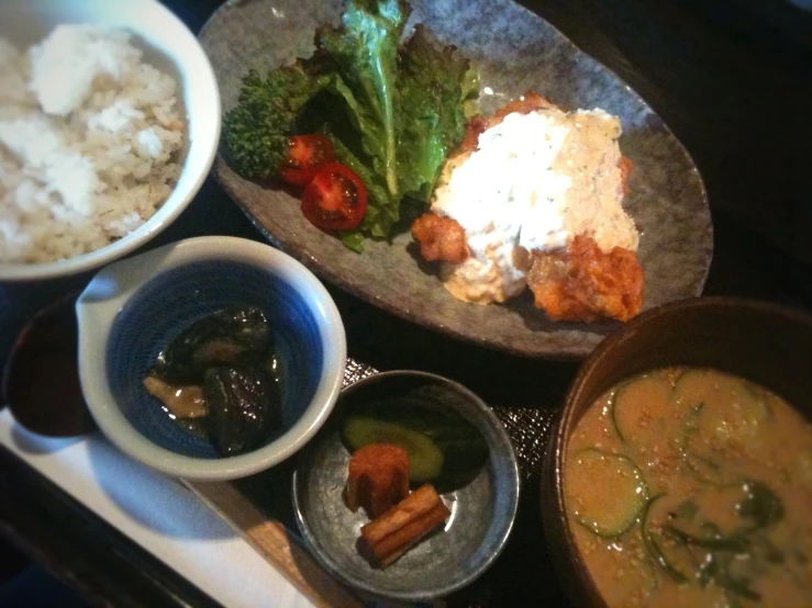 several bowls of food are on a table