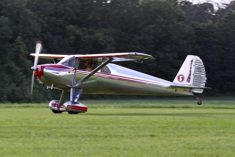 small plane sitting out on the runway at an airport