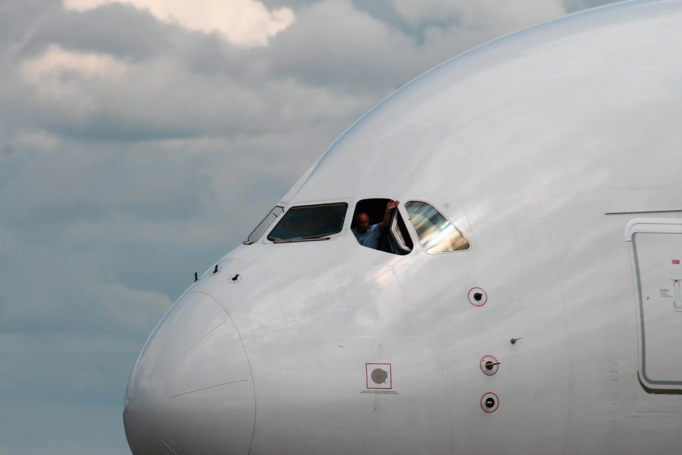 a airplane cockpit and windows with clouds in the background