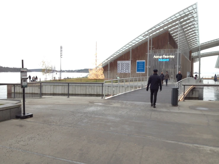 two people walking towards a building in the sun